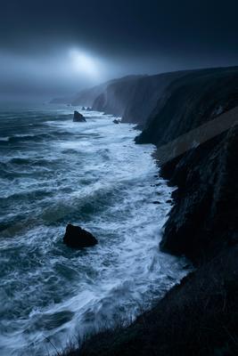 A night long exposure water scene of ocean, fog.