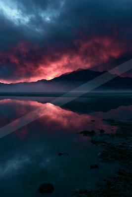 A blue hour water scene of lake, sunrise, reflection.