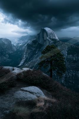 A dramatic landscape of mountains, valley, rocks.