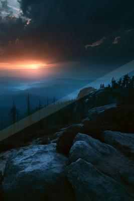 A blue hour sky scene of sunrise, valley, mountains.