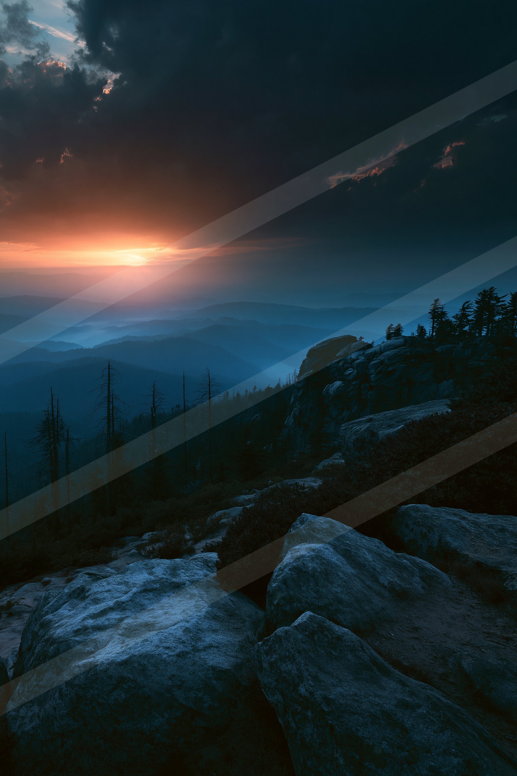 A breathtaking sunset over a mountainous landscape with silhouettes of trees and rocky terrain in the foreground.