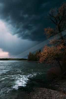 A dramatic high contrast sky scene of a storm, reflection.