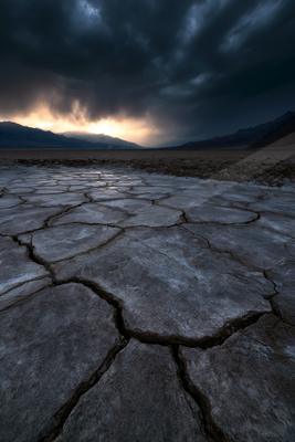 A moody landscape of desert, valley, lake.