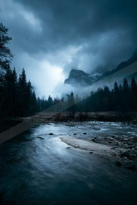 A black-toned moody photograph of valley, lakeside, seashore.