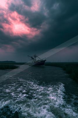 A brown-toned moody photograph of pirate, wreck, schooner.