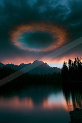 A dramatic water scene of lake, clouds, reflection.