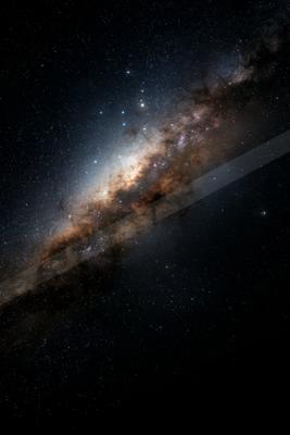 Detailed view of the Milky Way galaxy stretching diagonally across a dark night sky filled with countless stars and colorful cosmic dust clouds.