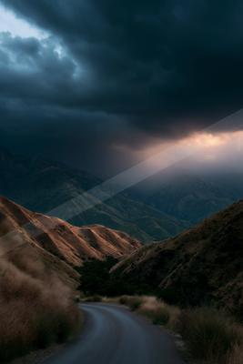 A black-toned moody photograph of volcano, mountain tent, valley.