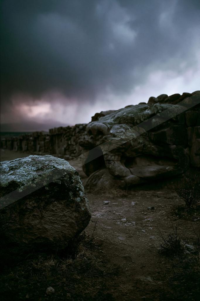 A night sky scene of storm, clouds, rocks.