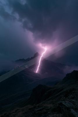 A black-toned moody photograph of volcano, alp, mountain tent.