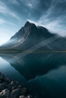 A mysterious symmetry landscape of a mountains, reflection.