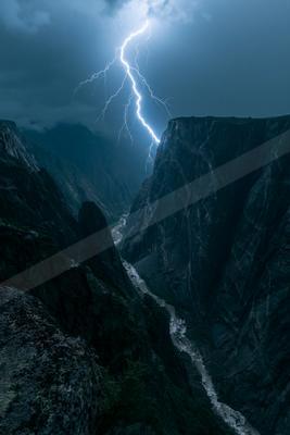 A black-toned moody photograph of valley, alp, cliff.