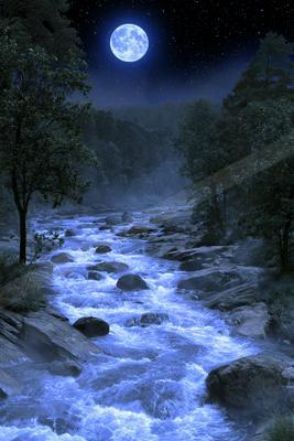 A rushing river with white water flows over rocks between dark trees under a large bright full moon and starry night sky.