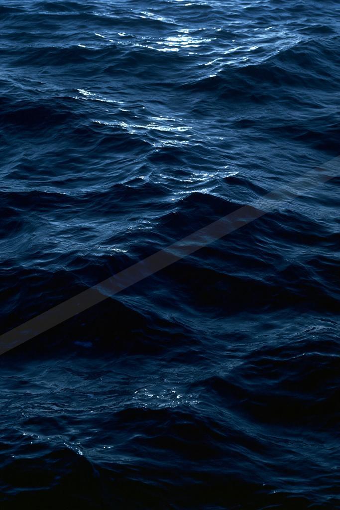 A blue hour water scene of ocean, abstract texture.