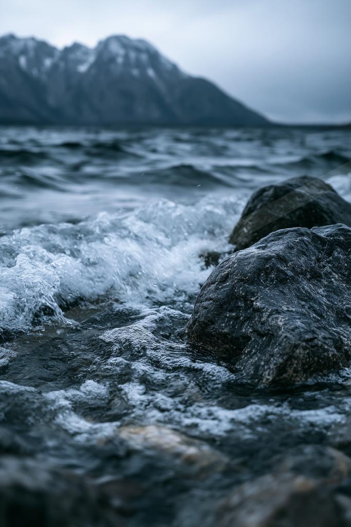 A moody motion blur water scene of an ocean, rocks.