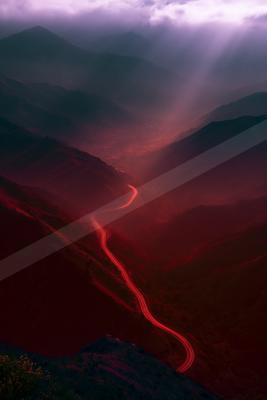 A moody water scene of river, mountains, valley.