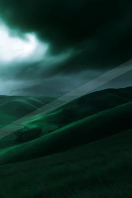 A moody landscape of field, storm, clouds.