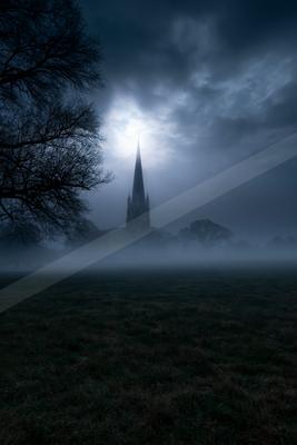 A black-toned moody photograph of church, obelisk, castle.