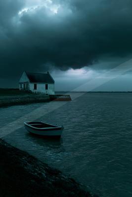 A small white house sits on a stone jetty beside a choppy body of water under a dark, ominous stormy sky, with a small rowboat floating in the foreground.