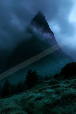 A sharp rocky mountain peak rises through thick fog and low clouds under a dark blue twilight sky, with grassy slopes and coniferous trees in the foreground.