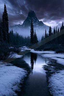 A mysterious high contrast landscape of a mountains, reflection.