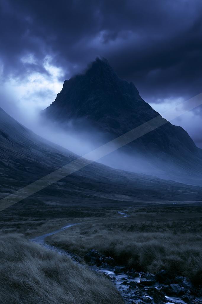 A moody landscape of mountains, valley.