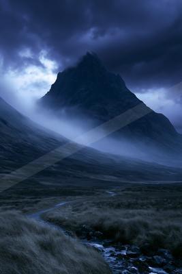 A moody landscape of mountains, valley.