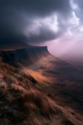 A dramatic sky scene of storm, mountains, valley.