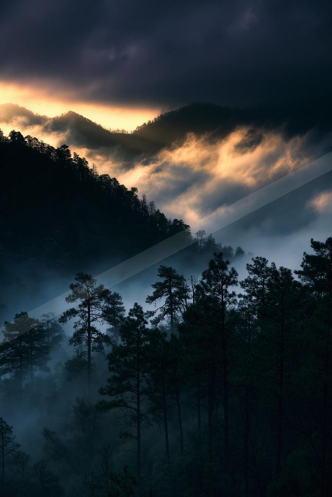 A serene mountain landscape shrouded in misty clouds during twilight.