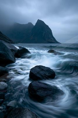 A dramatic long exposure water scene of ocean, river, beach.