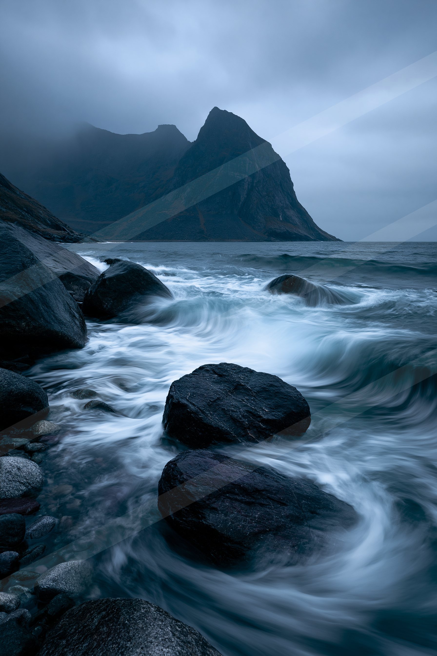 A mysterious long exposure water scene of a coastline, rocks.