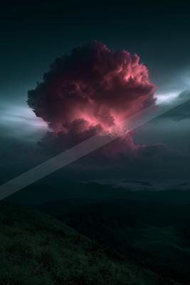 A massive, billowing storm cloud illuminated in vivid pink and magenta rises dramatically against a dark, moody sky above rolling green hills.