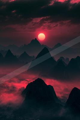 A striking red sunset casts a vivid glow over jagged mountain silhouettes, creating an otherworldly atmosphere.