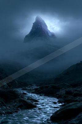 A moody landscape of mountains.