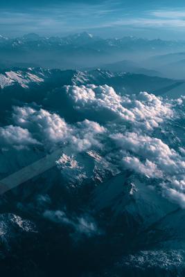A moody landscape of mountains, clouds.