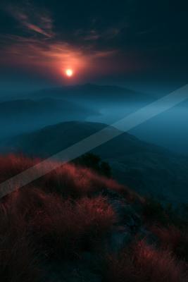 A blue hour sky scene of sunrise, mountains, valley.
