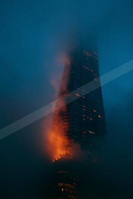 A blue-toned moody photograph of volcano, torch, obelisk.