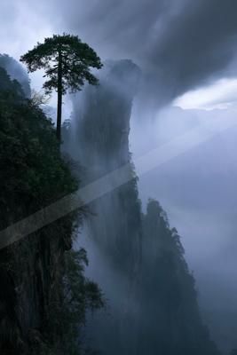 A dramatic sky scene of storm, waterfall, mountains.