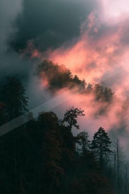 A brown-toned moody photograph of volcano, lakeside, geyser.