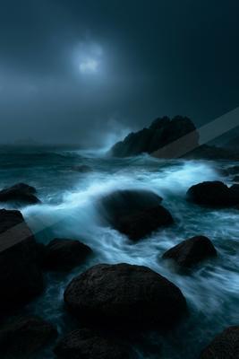 A night long exposure water scene of ocean, rocks.