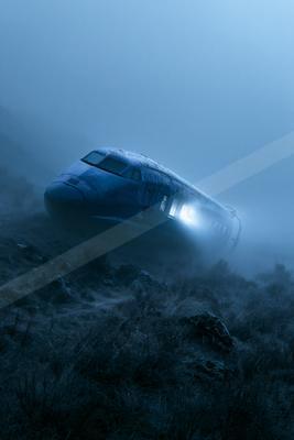 A crashed passenger airplane lies tilted on a rocky, grassy hillside shrouded in thick blue fog, with a bright light glowing from an open doorway.