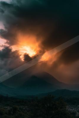 A dramatic sky scene of storm, clouds, mountains.