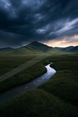 A moody water scene of river, valley, field.