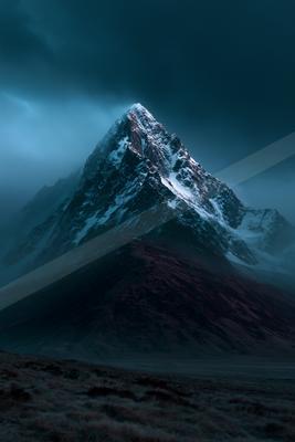 A sharp, snow-covered mountain peak rises through thick, moody clouds against a dark teal sky, with a reddish-brown grassy foreground slope.