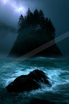 A night water scene of ocean, fog.