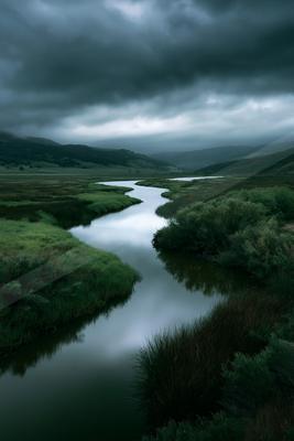 A serene long exposure water scene of river, lake, valley.