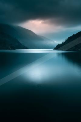 A blue hour long exposure water scene of a lake, reflection.