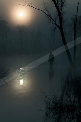 A black-and-white moody water scene of lake.