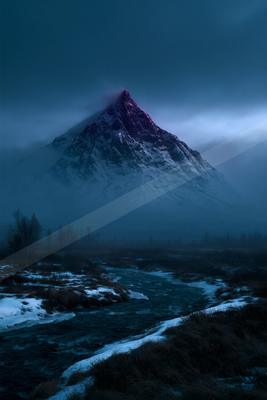 A majestic snow-covered mountain peak rises above a misty valley, illuminated by a purple-pink glow at its summit, with a dark flowing river winding through a s