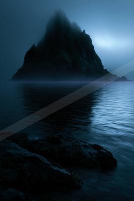 A blue hour water scene of lake, mountains, ocean.